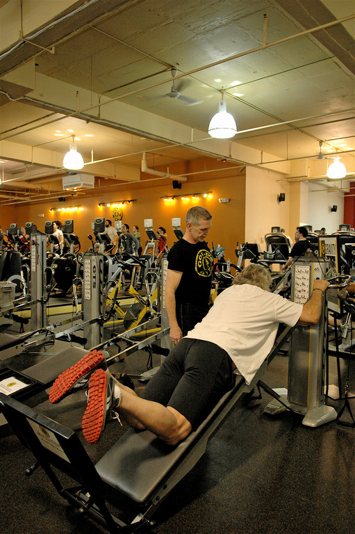 Gold's Gym Trainer Charlie Robbins leads a client through a GTS session