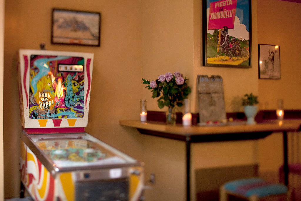 The dining room has an open floor plan with counters for dining and a pinball machine