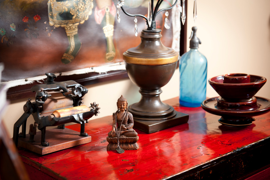"To the left is a pasta maker. My maternal great grandmother brought it over on the boat from southern Italy. Somehow it survived the trip. I found it in my grandfather’s house – it was one of the few things he still had from her. In the front is a Buddha piece that was hand carved in Nepal by a local wood cutter who used a technique particular to that region. In the back right corner is a water aerator (that they use to make seltzer) from the 1920s. I found it in a flea market in Buenos Aires when I was looking for jewelry inspiration."