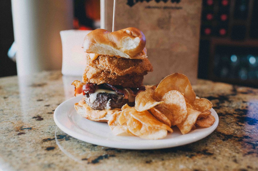 Hand-pressed burger with hot chili mayo, bacon and onion rings