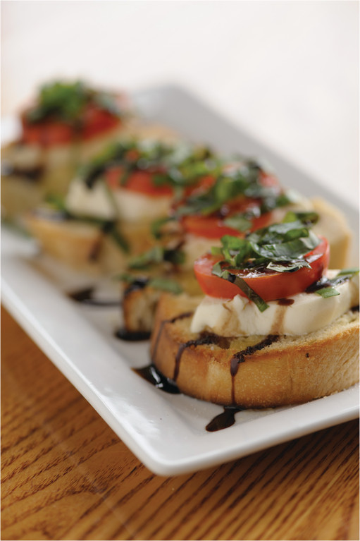 Caprese Salad: Fresh mozzarella topped with tomatoes, basil, extra virgin olive oil and balsamic glaze on homemade bread