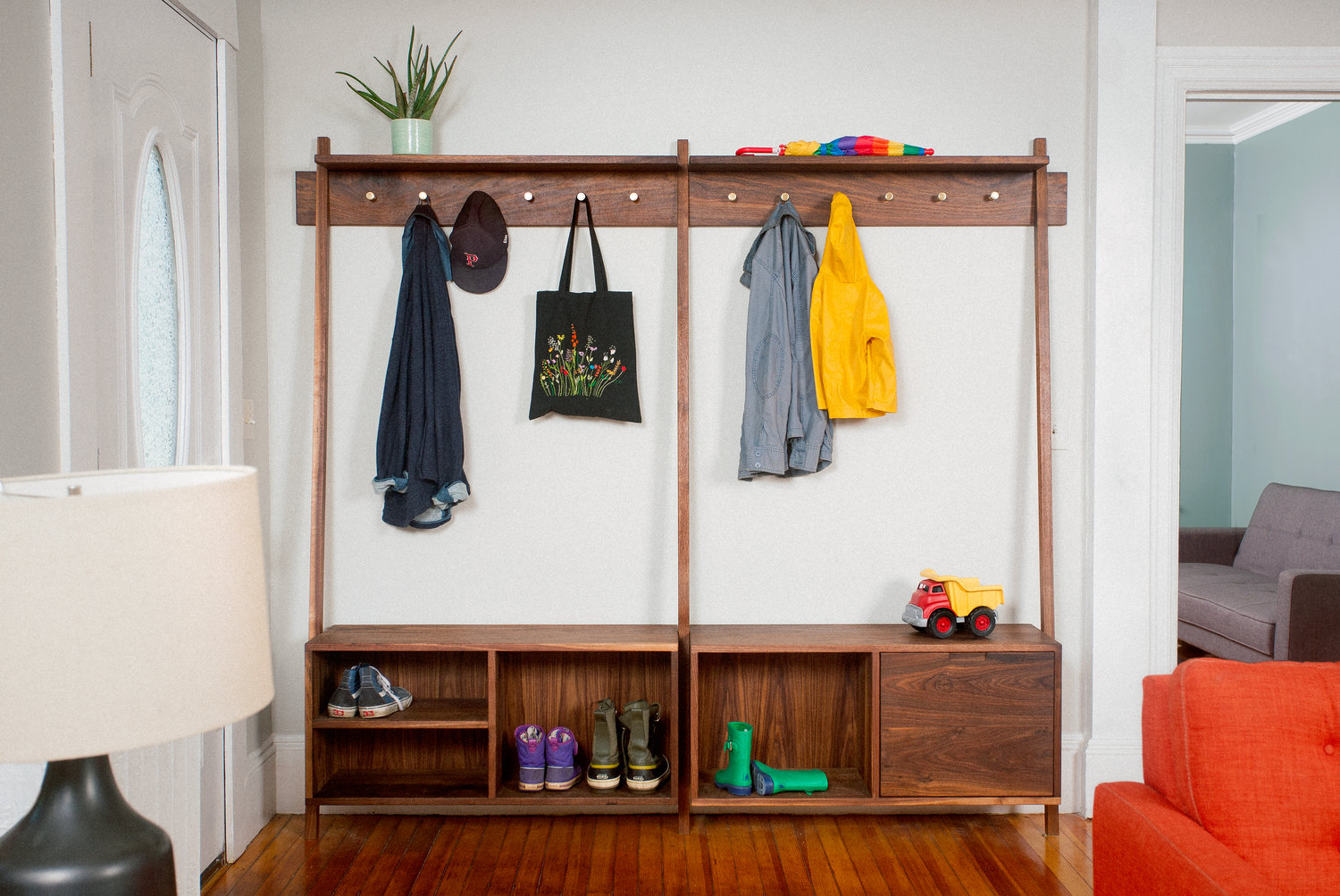 A coat hanger and storage bench transform the entryway into a mudroom