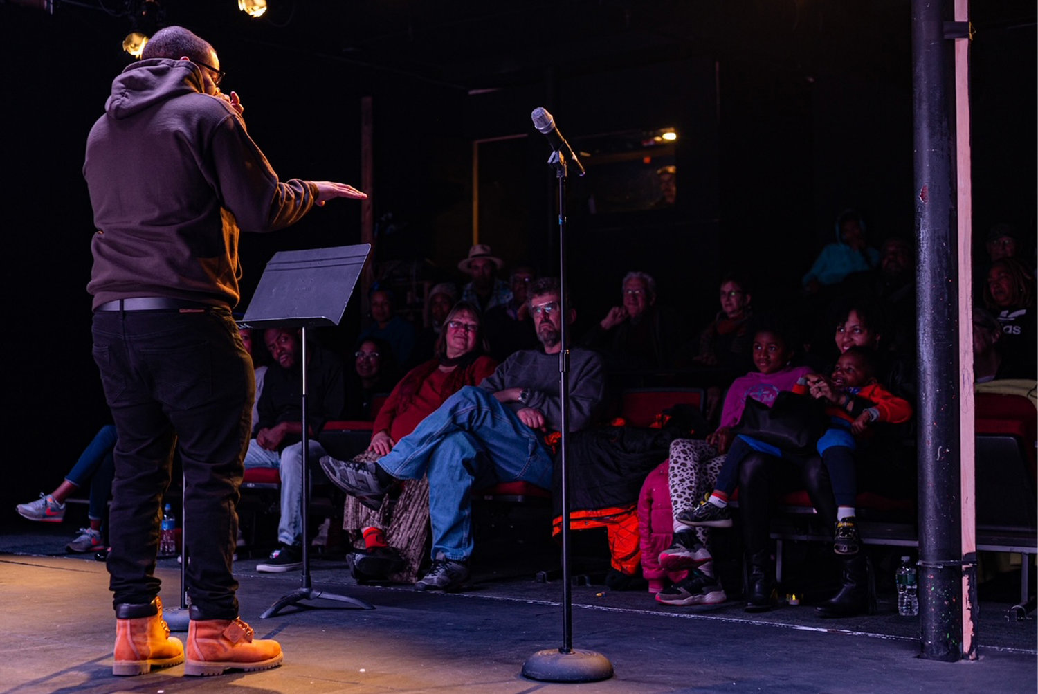 Poet Rudy Cabrera performs an original piece during Rise to Black at Mixed Magic Theatre