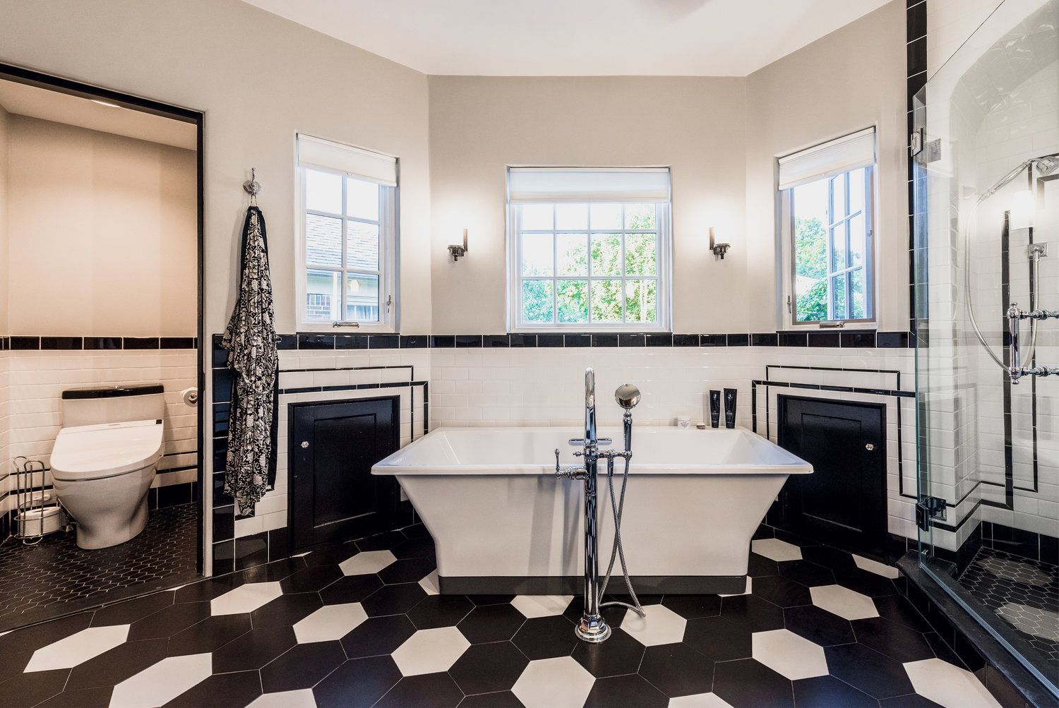 Existing small storage doors were kept and painted black to add more contrast to the wall tile and blend more seamlessly with the row of black wall tile along the floor